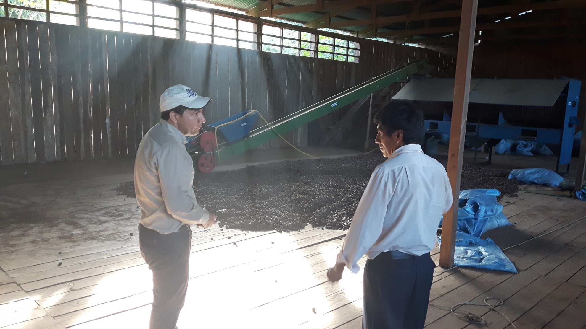 My colleague Juan Arévalo with President Eulogio Suxo in the, almost empty, Brazil nut warehouse of the cooperative agro-extractive COINACAPA in Porvenir, Department of Pando, Bolivia